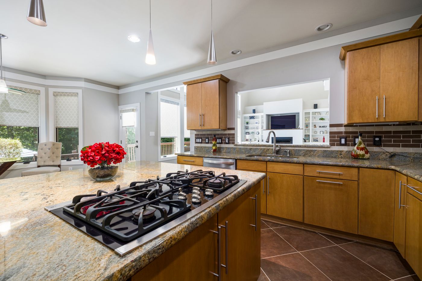 Wood cabinet kitchen with island and tile flooring