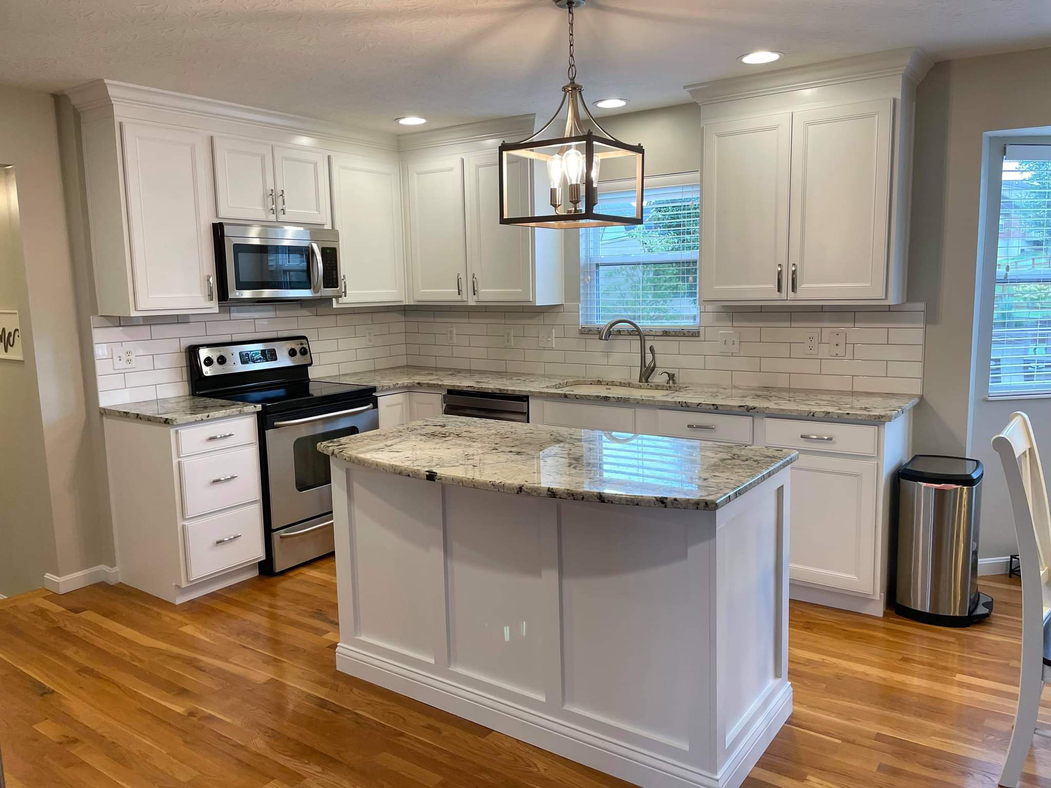 Northern Kentucky kitchen with white cabinets, an island and stainless steel appliances